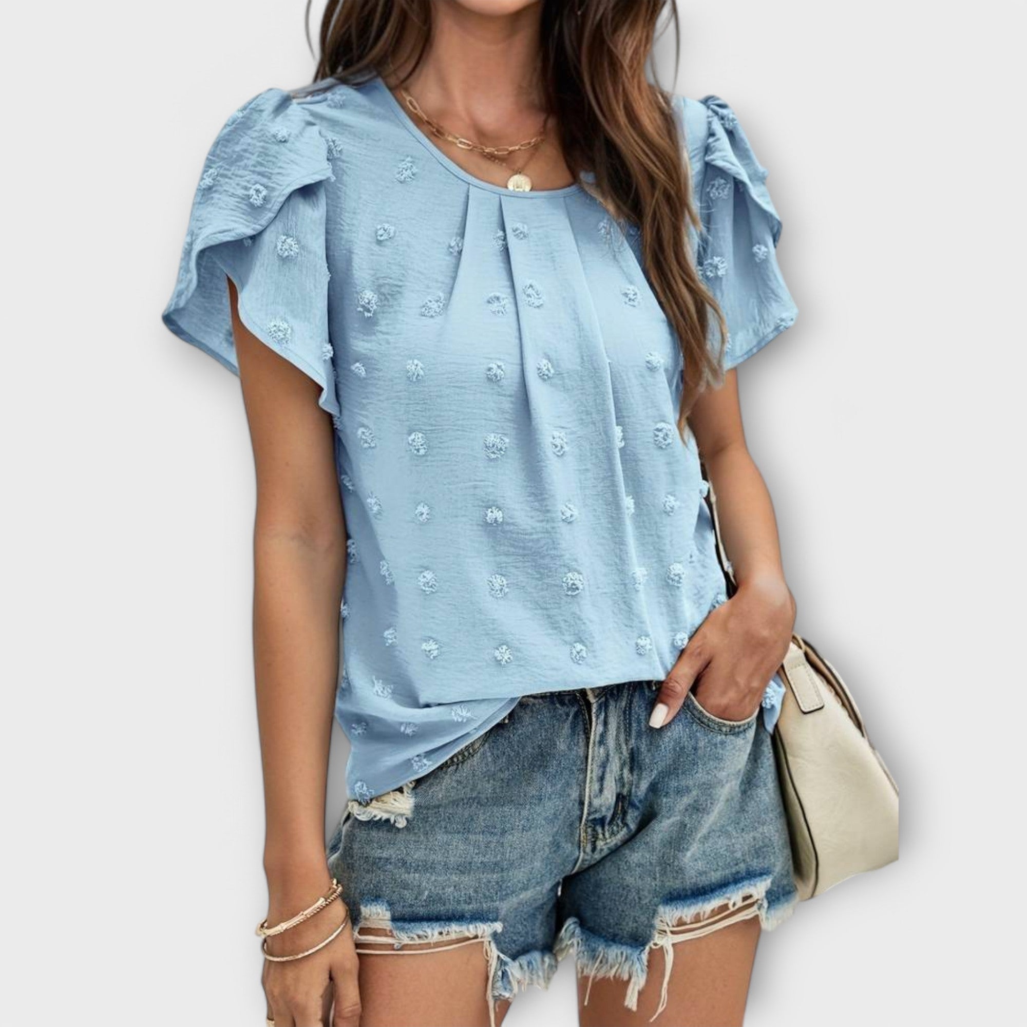 Maja | Blus med prickstruktur och blomformade ärmar