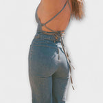 Stefanie | Utsvängd denim jumpsuit med knytdetalj